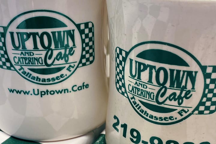 Two filled coffee mugs on the counter.